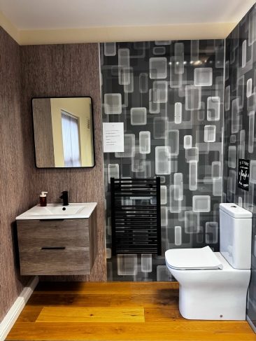 Bathroom Showroom showing sink, toilet and heated towel rail